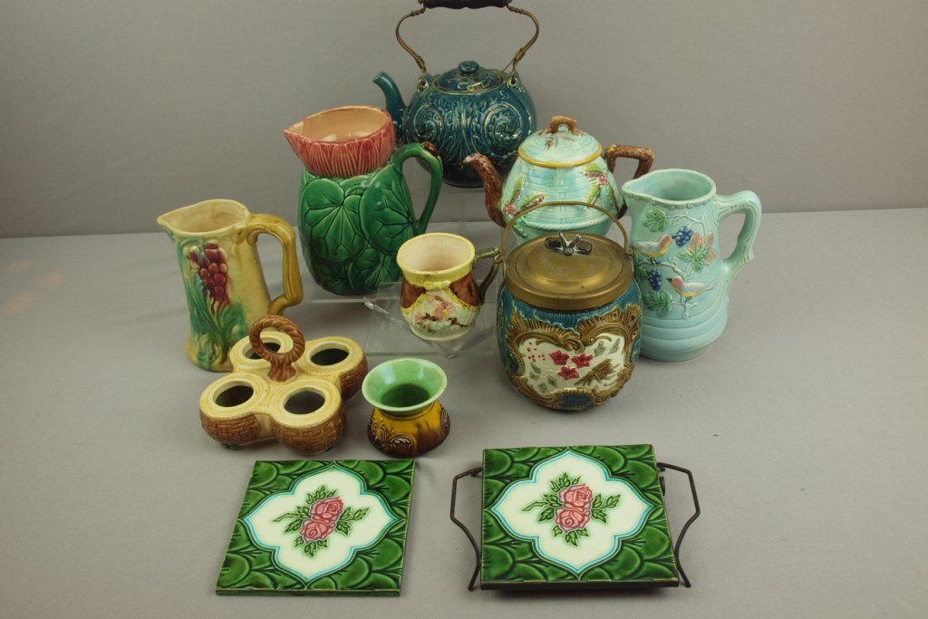 Majolica lot of 11 pieces - 2 teapots, 3 pitchers,: Majolica lot of 11 pieces - 2 teapots, 3 pitchers, biscuit jar, 2 tiles, egg cup holder, mug and spittoon, various condition