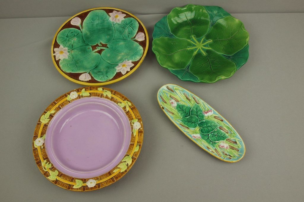 Majolica lot of 4 trays - George Jones cattail and: Majolica lot of 4 trays - George Jones cattail and water lily pen tray (repairs), George Jones picket fence cheese keeper tray, 10", hairline, Minton pond lily tray 10 1/2", hairline and pond lily pla