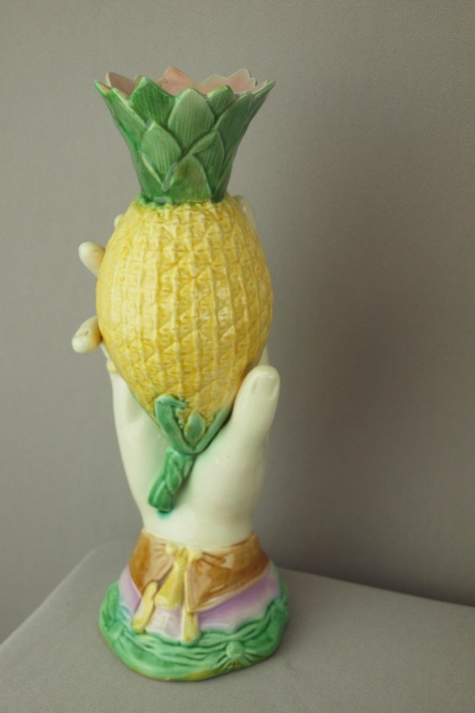 Majolica hand vase holding pineapple, professional: Majolica hand vase holding pineapple, professional repair to points, 10"