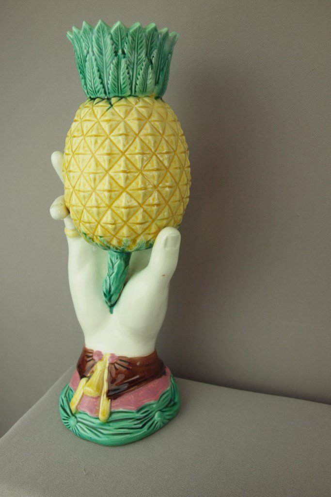 Majolica hand vase holding pineapple, professional: Majolica hand vase holding pineapple, professional repair to points, 13", English Registry mark