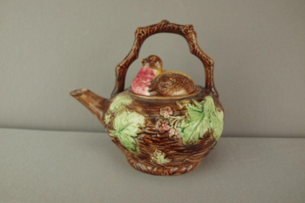 Majolica teakettle in the form of a bird's nest with: Majolica teakettle in the form of a bird's nest with bird lid and branch handle, 7"h
