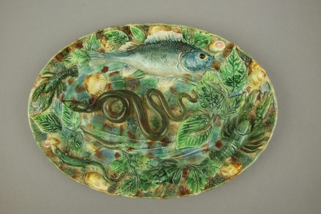 Longchamp French majolica Palissy oval plaque with: Longchamp French majolica Palissy oval plaque with fish, crayfish, frog and other sealife in relief, minor losses to high points, 15 1/2"