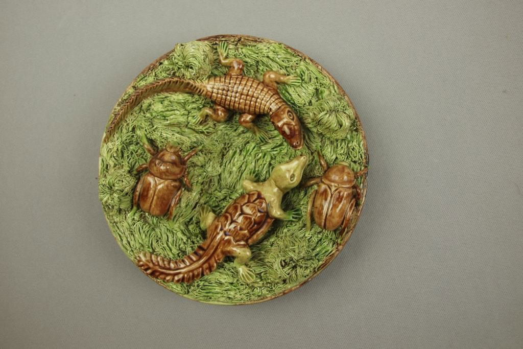Caldas Portugal Palissy Ware majolica round plaque with: Caldas Portugal Palissy Ware majolica round plaque with beetles and small aligators on heavy grass ground, 7 1/2"
