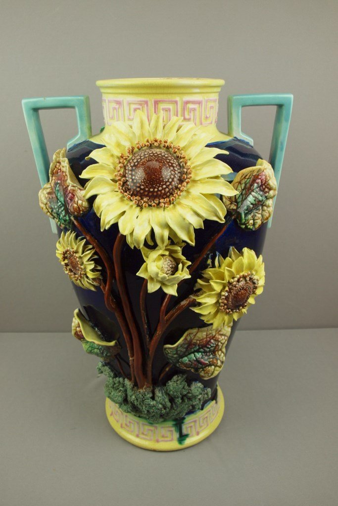Majolica monumental floor vase with applied sunflowers: Majolica monumental floor vase with applied sunflowers on one side and roses to the other, professional repairs to floral points, 23", attributed to Forester