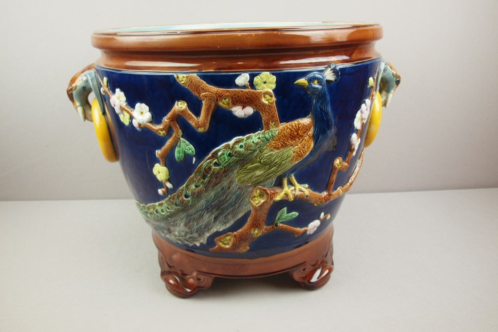 HOLDCROFT large majolica cobalt footed jardiniere with: HOLDCROFT large majolica cobalt footed jardiniere with peacock on each side and elephant handles, 16 1/2"h, 23"w, professional rim and foot repair