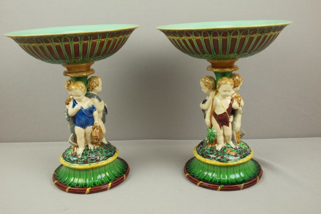 MINTON majolica pair of compotes each with a group of: MINTON majolica pair of compotes each with a group of male hunters with dog, one hunter with a rabbit, one with quail and the other with fish, shape no. 657, 11 1/2"h, 9 1/4"d