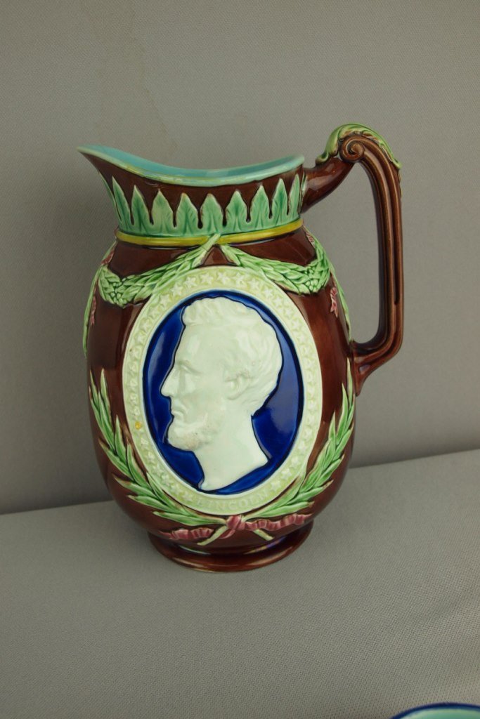 WEDGWOOD majolica Centennial jug with profile of: WEDGWOOD majolica Centennial jug with profile of Washington on one side and Lincoln on the other, 8", minor hairline to spout
