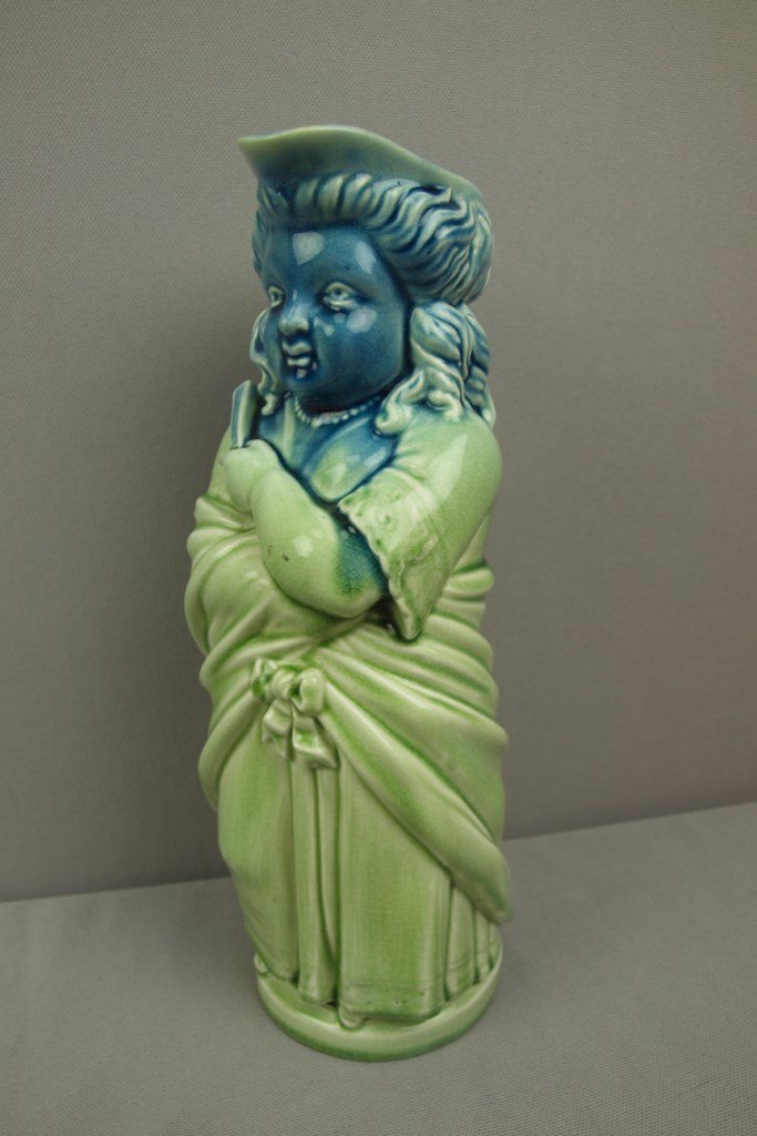 MINTON majolica figural Toby pitcher in the form of a: MINTON majolica figural Toby pitcher in the form of a lady in shades of green and blue, unusual color, 11", professional spout repair
