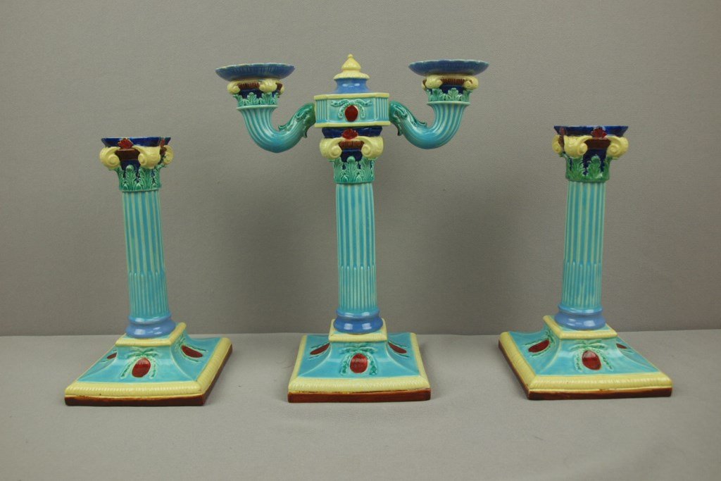 Royal Worcester majolica three piece garniture set with: Royal Worcester majolica three piece garniture set with two lite center candle and pair of matching single candle holders, 10 1/4" and 8 1/2", professional repair to top rims