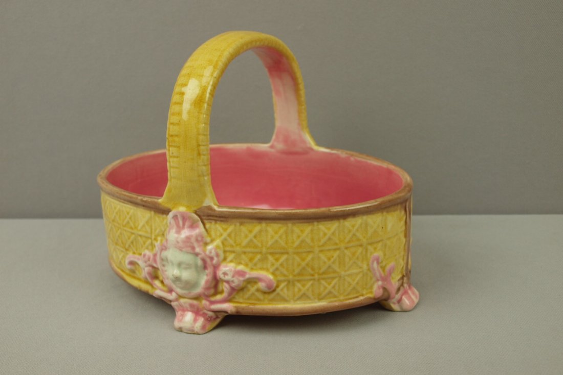 Majolica basket with angel faces on side 6 1/2"h: Majolica basket with angel faces on side 6 1/2"h