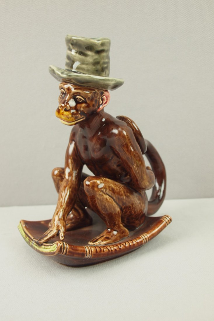 Sarreguemines rare figural monkey chamber stick, #1213,: Sarreguemines rare figural monkey chamber stick, #1213, professional repair to tail, monkey seated on "Darwin" book