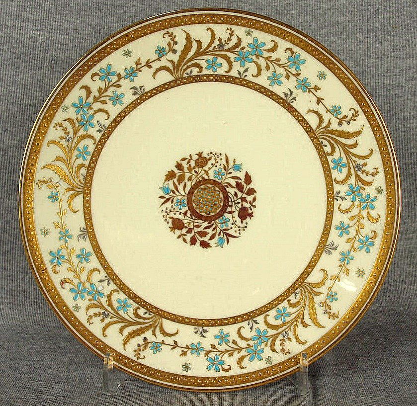 An excellent quality Minton bone china aesthetic: An excellent quality Minton bone china aesthetic movement plate decorated with a border of gilt floral sprays highlighted with platinum and turquoise enameling, with circular pattern of gold and turqu