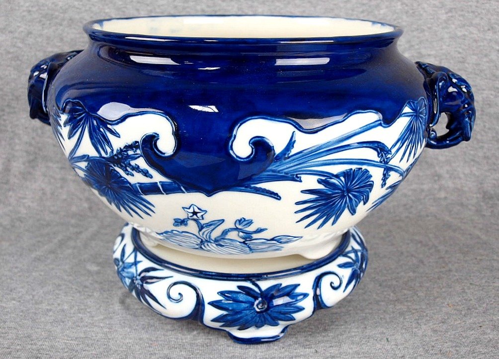 A very rare Minton Aesthetic movement blue and white: A very rare Minton Aesthetic movement blue and white cachepot on stand, elephant head handles on bowl, base has three scroll feet and decorated with bamboo leaves. c1875, 14"w, 9"h, 'Design registered