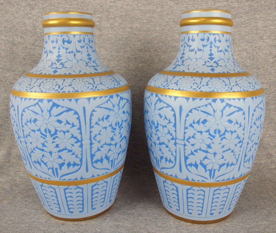 A very unusual pair of Grainger Worcester powder blue: A very unusual pair of Grainger Worcester powder blue aesthetic movement vases with carved panels of Christopher Dresser style panels c1865, 11", nick to base rim of one