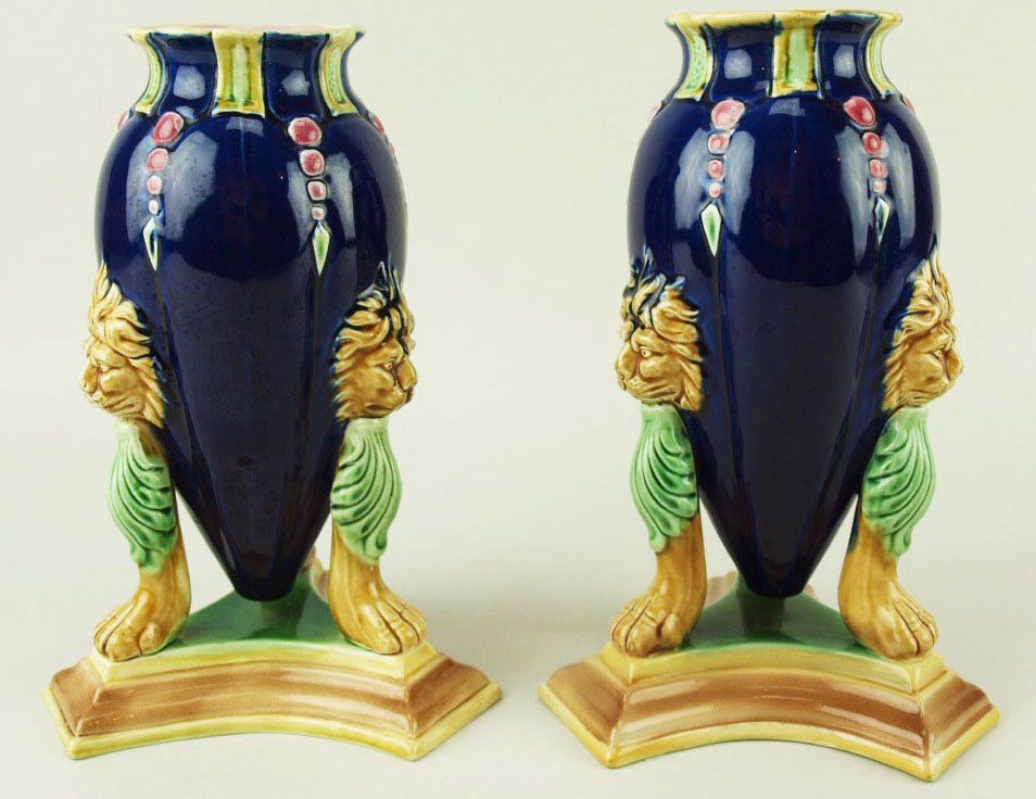 A very good quality pair of Holdcroft Neo-Classical: A very good quality pair of Holdcroft Neo-Classical cobalt ground amphora vases supported on lions paws and green acanthus with pale brown lion heads to the bodies, deep pink beads and green strap wor