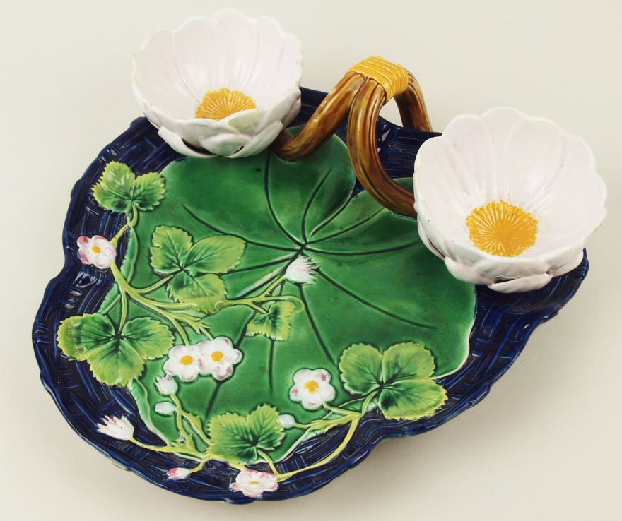 A Fine George Jones Majolica Strawberry Server c.1875,: A Fine George Jones Majolica Strawberry Server c.1875, length 12”, marked, Shape No. 3501 Modeled as a large green water lily scattered with strawberry plants on a cobalt basket, with two large whit