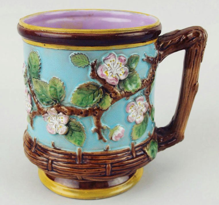 A rare George Jones Majolica ‘Apple Blossom’ beer mug: A rare George Jones Majolica ‘Apple Blossom’ beer mug c.1875, the turquoise body with a band of basket weave to the bottom quarter and trailing apple blossom to the top with a brown bark handle an