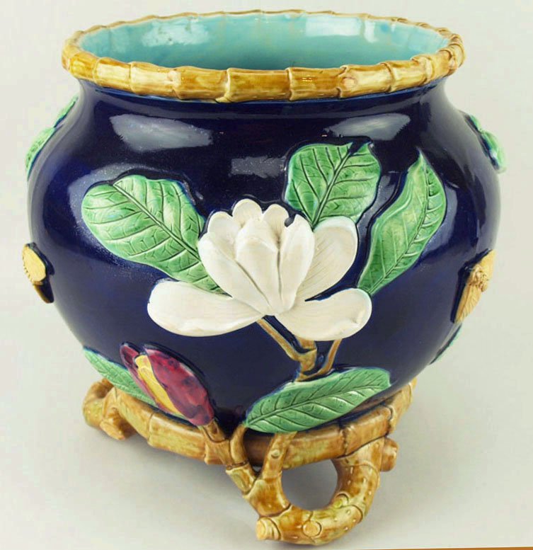 An excellent quality George Jones Magnolia jardiniere: An excellent quality George Jones Magnolia jardiniere c.1875, the ovoid cobalt body decorated with large magnolias and a bamboo top edge all supported on three undulating bamboo cane feet and with a t