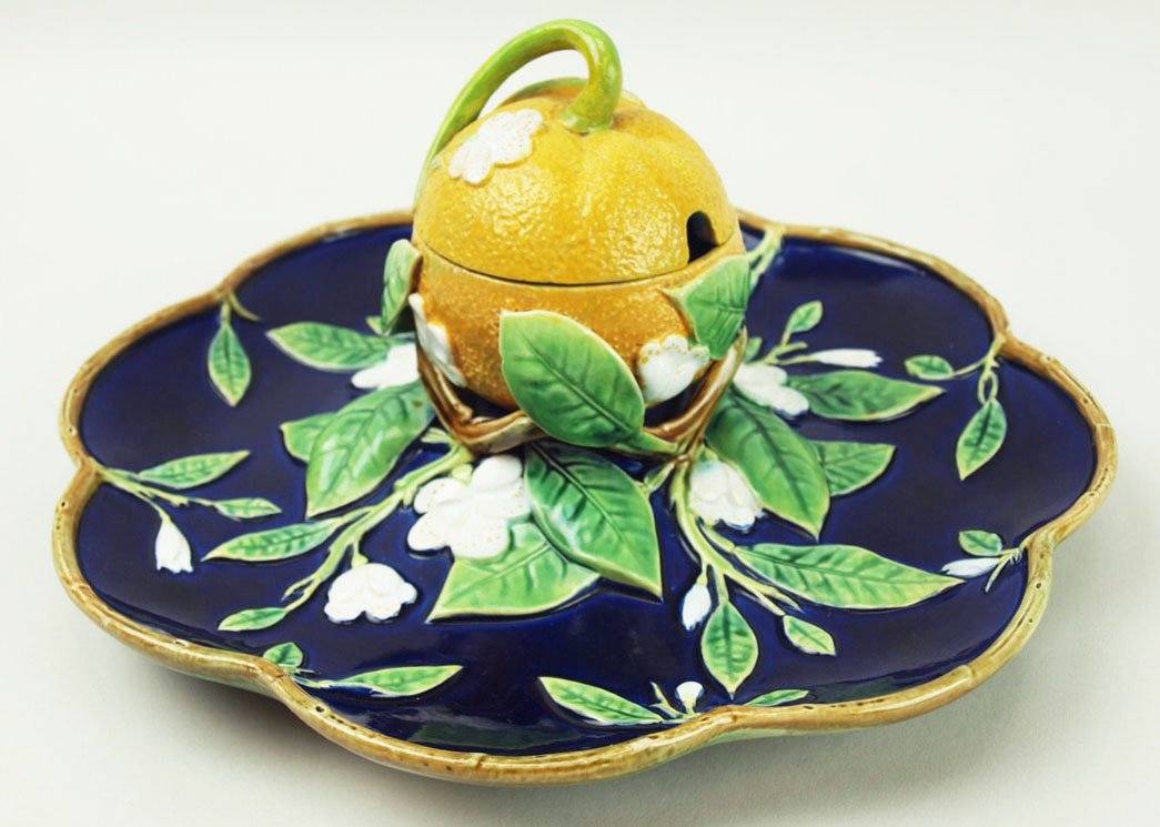 A very rare and extremely good quality George Jones: A very rare and extremely good quality George Jones Majolica marmalade server c.1875, the cobalt shaped dish decorated with orange blossoms and a branch edge, central twigs supporting a large orange, 