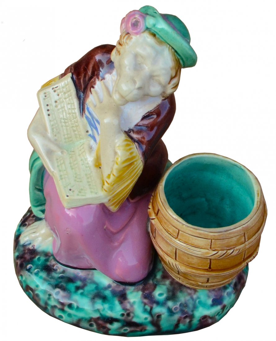 An extremely rare Minton Majolica singing monkey posy: An extremely rare Minton Majolica singing monkey posy holder c.1875 designed by Albert Carrier Bellouse, height 4”, marks, modeled as a singing monkey dressed in 18th century costume with an open so