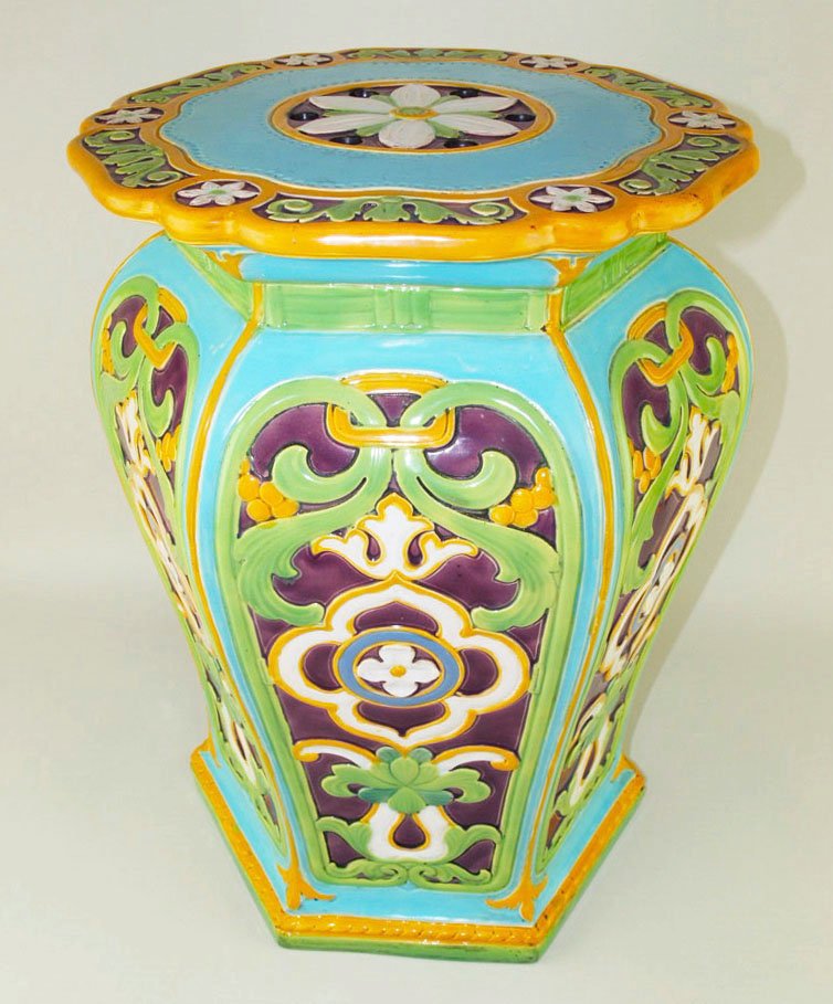 A fine Minton Majolica garden seat c.1875, designed as: A fine Minton Majolica garden seat c.1875, designed as a hexagonal baluster shaped seat with panels of colourful arabesques and a central flow head to the top, all on a turquoise ground.$2000 - $4000 