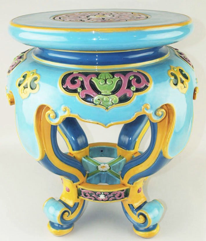 An excellent quality Minton Majolica garden seat in: An excellent quality Minton Majolica garden seat in the Chinese style c.1875, modeled as a faux hardwood pedestal with four scroll legs connected with panels of pink scrolling designs on a deep grey g