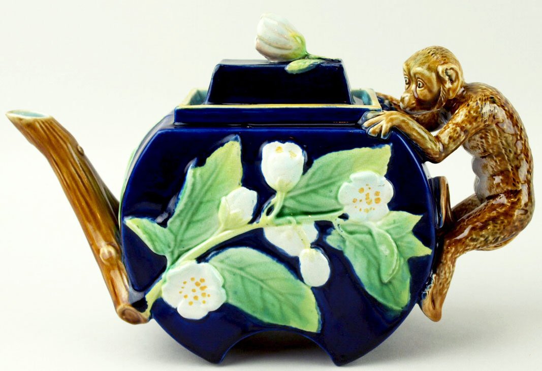 An excellent example George Jones Majolica teapot: An excellent example George Jones Majolica teapot c.1875, modeled as a cobalt body decorated with leaves and blossoms, with a monkey forming the handle and with a branch spout, a flower bud forming th