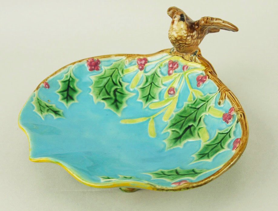 A charming George Jones Majolica Christmas dish: A charming George Jones Majolica Christmas dish .c1875, modeled as a shaped turquoise ground dish decorated with sprigs of holly surmounted by a small bird with outstretched wings, all supported on tw