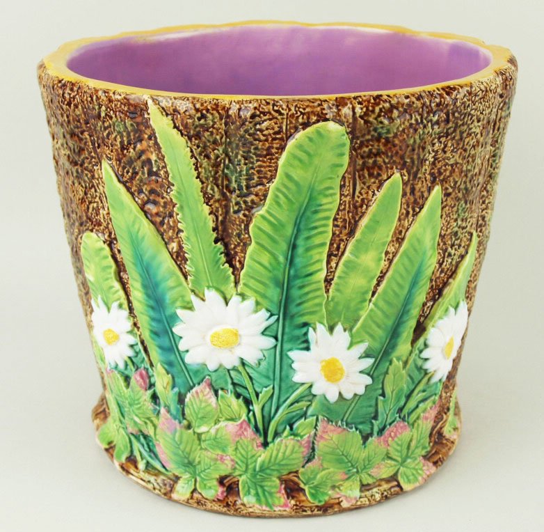A George Jones banana leaf jardiniere, c.1875, the: A George Jones banana leaf jardiniere, c.1875, the dimpled, straight sided, brown glazed body decorated with banana leaves and daisies with a pink interior, 8”h, 9”d 'CURATED & CATALOGUED BY NICOL