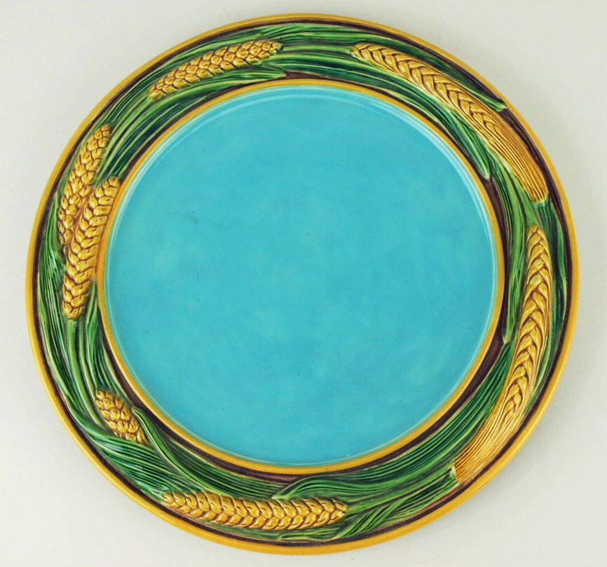 A large circular Minton Majolica bread tray c.1860,: A large circular Minton Majolica bread tray c.1860, designed with a large turquoise centre and wide border decorated with wheat and framed within thin orange glazed borders, 12 ½” 'CURATED & CATALO