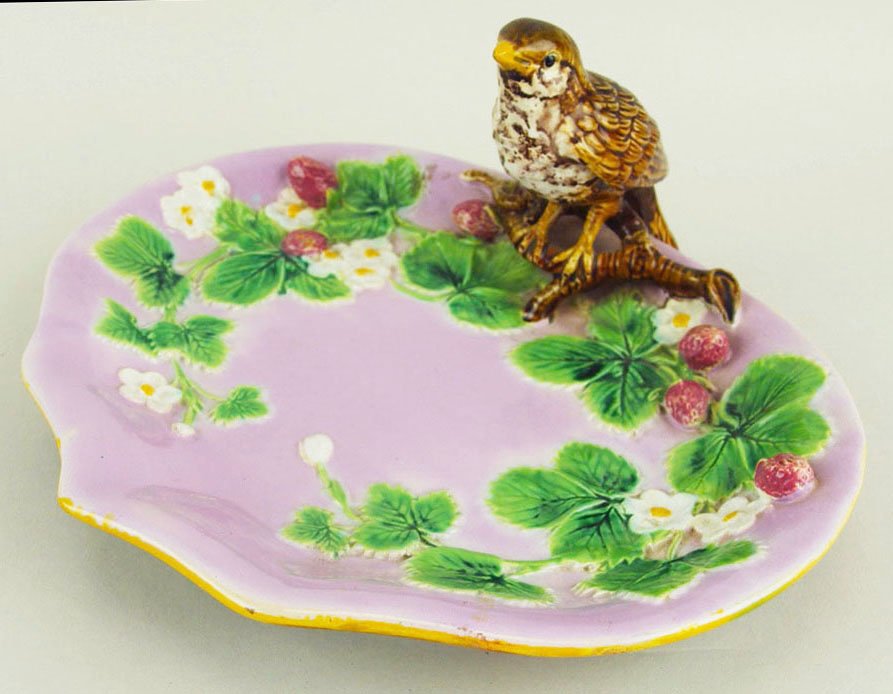 An excellent quality and rare coloured George Jones: An excellent quality and rare coloured George Jones Majolica Strawberry serving dish c.1875, 10 ¼”w, modeled as a thrush perched on a branch set on a shaped, pink glazed dish adorned with fruiting 