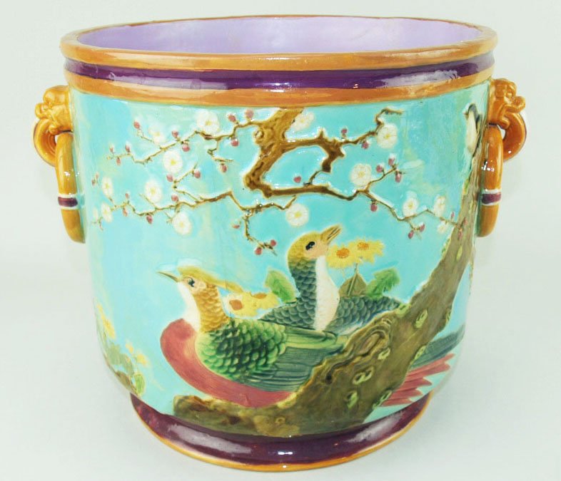 A Minton Majolica Asiatic pheasant jardiniere c.1870,: A Minton Majolica Asiatic pheasant jardiniere c.1870, designed as a turquoise ground straight sided jardiniere decorated in the Japanese style with prunus blossoms, Asiatic pheasant, and Foo dogs with