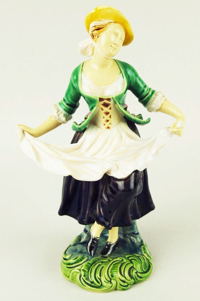 A very rare Minton Majolica figure of a dancing lady.: A very rare Minton Majolica figure of a dancing lady. c1875, shape no 109, designed as a lady in 18th century costume holding her apron as she dances. This design was originally intended for porcelain