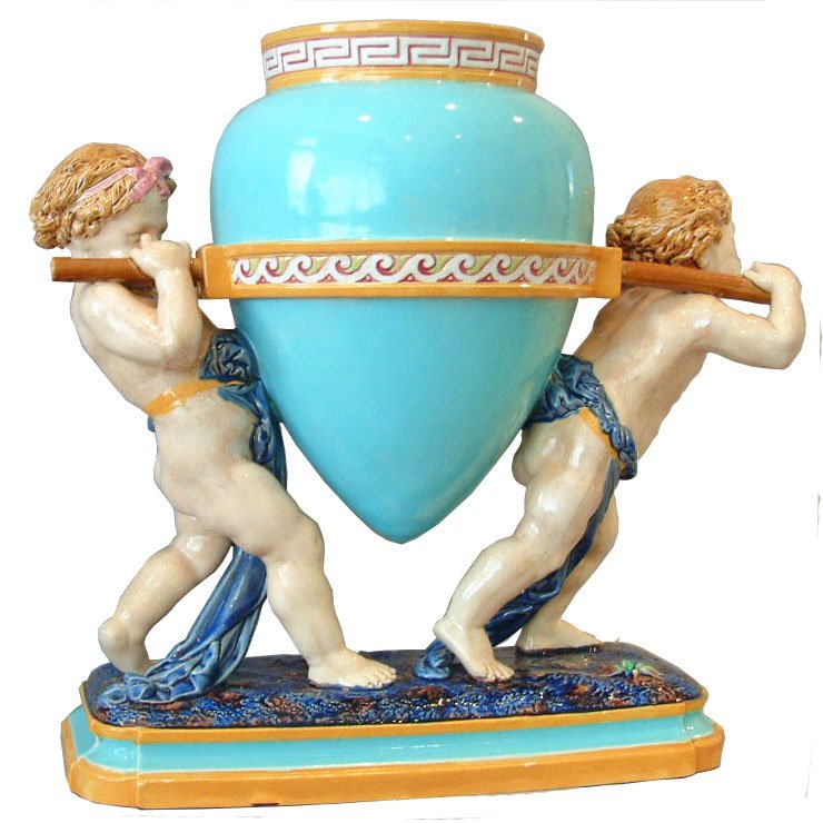 An impressive Minton Majolica cherubs vase c.1875,: An impressive Minton Majolica cherubs vase c.1875, designed by Carrier Belleuse, shape no. 1517, modeled as two cherubs carrying a large turquoise amphora decorated with a with a collar of yellow and