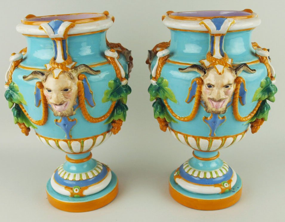A pair of Minton Majolica mantle vases c.1855, each of: A pair of Minton Majolica mantle vases c.1855, each of baluster form and molded in high relief with ochre-glazed foliate swags and three naturalistic a satyrs-masks on a ground glazed in turquoise-blu