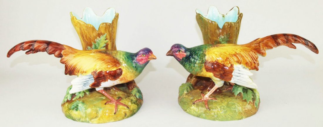 A beautifully painted pair of Jerome Massier Majolica: A beautifully painted pair of Jerome Massier Majolica vases c.1880, each modeled as brightly and well painted golden pheasant in front of an open tree trunk forming the flower holder with a turquoise