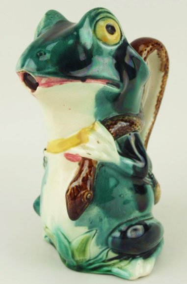 A charming and whimsical Orchies Majolica water: A charming and whimsical Orchies Majolica water pitcher ‘The Frog Hunter’ c.1880, 8 ½”. Modeled as a bright eyed emerald green frog with a captured snake over one shoulder forming the handle, h