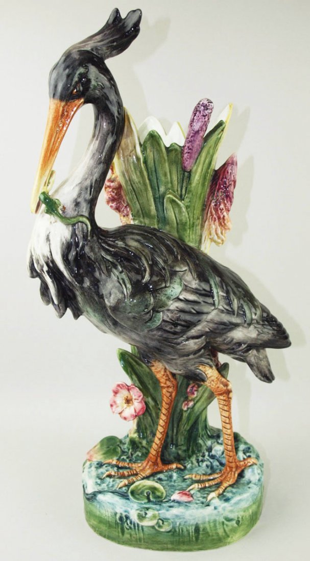 . A handsome Royal Dux Majolica heron flower vase: . A handsome Royal Dux Majolica heron flower vase c.1890, Modeled as a grey heron with a lizard in his beak standing in front of a vase formed of large leaves and brightly coloured cattails, all upon 