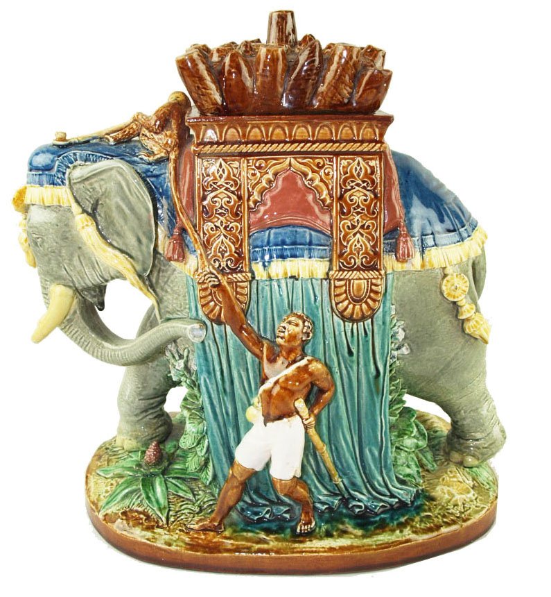 A Rare and Finely Modelled Gien Majolica Elephant: A Rare and Finely Modelled Gien Majolica Elephant Tobacco Box & Cover c.1880, 13”h. Designed as an Indian Grey Elephant in Ceremonial dress with Alhambra decorated Howdah being driven by a small boy