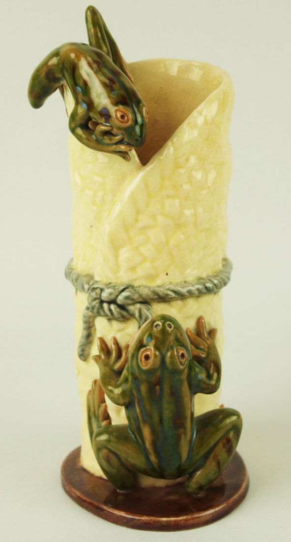 A Rare & Humorous Raphael Bordalo Pinheiro Majolica: A Rare & Humorous Raphael Bordalo Pinheiro Majolica Vase c.1880. The vase modeled as a wrapped cream glazed basket bound with grey string with two green frogs climbing the sides, 6 ¾”. 'CURATED & C