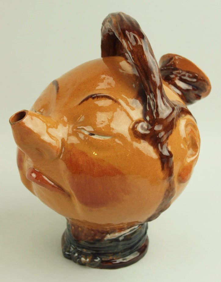 A Very Rare & Amusing Raphael Bordalo Pinheiro: A Very Rare & Amusing Raphael Bordalo Pinheiro Majolica Milk jug Entitled ‘Chinese Sloth’ c. 1880, Caldas Da Rainha, Portugal. Height 9” Modeled as a round face man with rosy cheeks and a white 