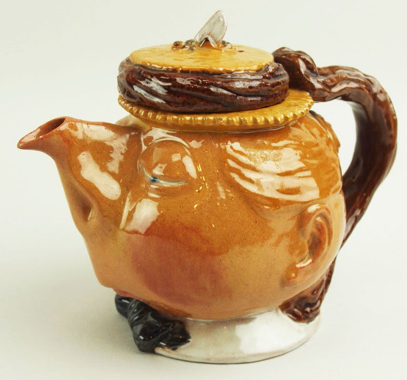 A Very Rare & Amusing Raphael Bordalo Pinheiro: A Very Rare & Amusing Raphael Bordalo Pinheiro Majolica Teapot & Cover Entitled ‘The English Lady’ c.1880, Caldas Da Rainha, Portugal Modeled as a woman’s head with her nose as the spout & a str