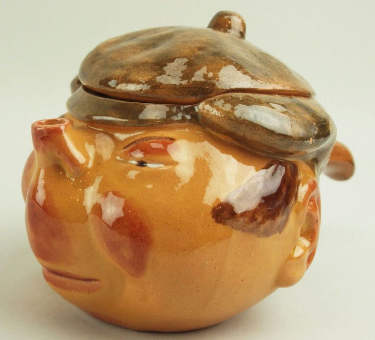 A Very Rare & Amusing Raphael Bordalo Pinheiro: A Very Rare & Amusing Raphael Bordalo Pinheiro Majolica Teapot & Cover, probably depicting the working man. c.1880, Caldas Da Rainha, Portugal. Height: 6. Modeled as a ruddy cheeked man with a simple 
