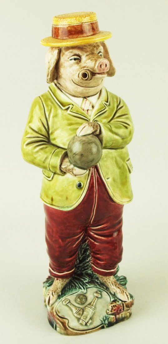 A B&L Gesetzl Gesch Majolica bowling pig Decanter: A B&L Gesetzl Gesch Majolica bowling pig Decanter c.1875 (not marked) Designed as a cigar smoking pig wearing a green jacket, red trousers and a straw boater on his head and readying himself to roll a