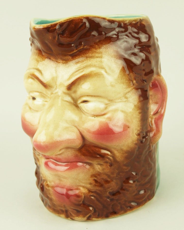A Rare Sarreguemines Water pitcher “The Boozer”: A Rare Sarreguemines Water pitcher “The Boozer” c.1880, Height 9”, shape # 3323.Provenance: Helen Cunningham. This hard to find pitcher is modeled as a red haired, bearded man with red cheeks an