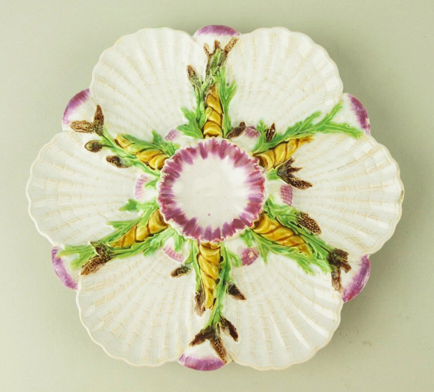 A Rare and beautifully coloured George Jones Majolica: A Rare and beautifully coloured George Jones Majolica 6 well oyster plate. c.1875 Modeled as a circular plates with 6 white shell shapes wells separated by green and brown seaweed and pale yellow twis