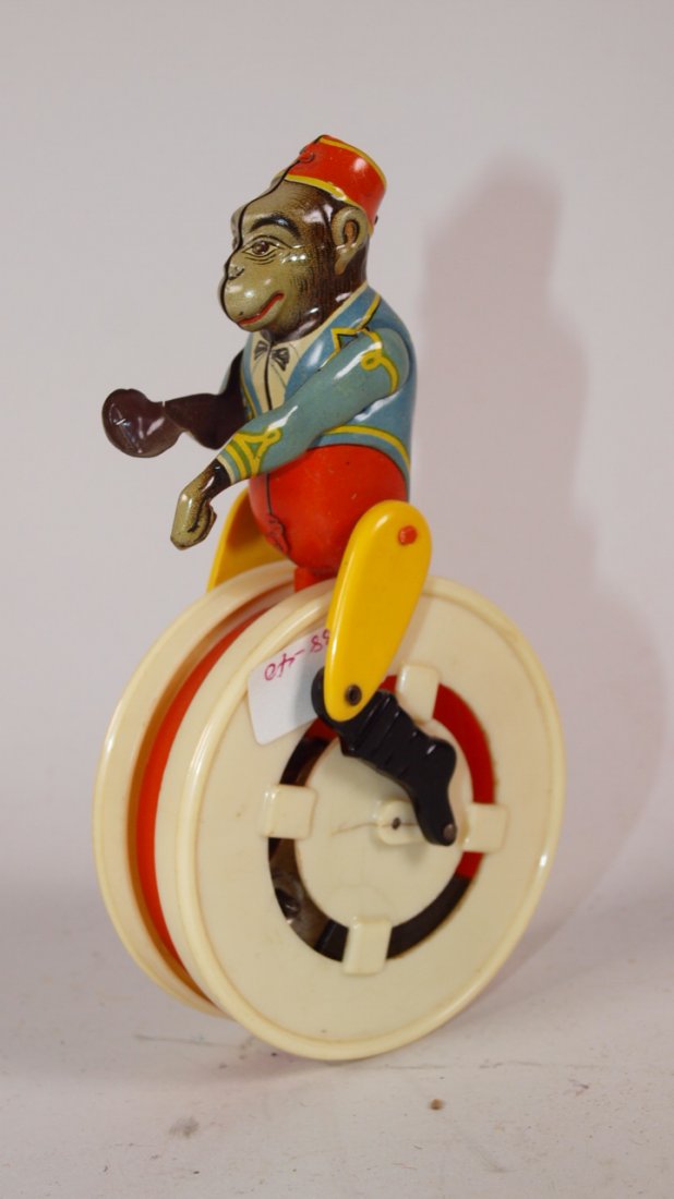 German tin litho monkey unicycle wind up toy: German tin litho monkey unicycle wind up toy