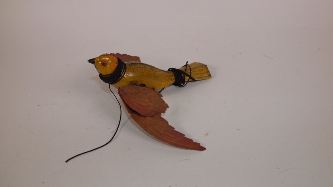 Early tin litho flying bird with cardboard wings: Early tin litho flying bird with cardboard wings