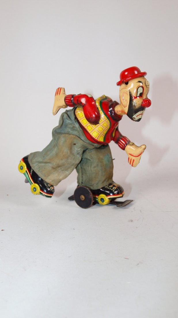 Tin litho TPS Japan clown roller skater wind up toy: Tin litho TPS Japan clown roller skater wind up toy