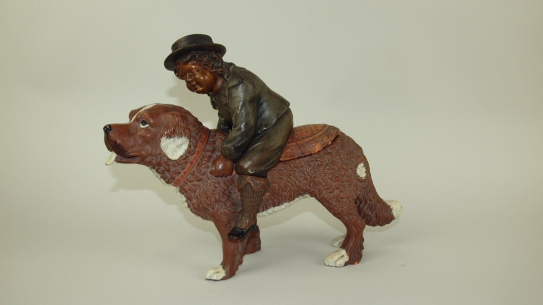 Terra Cotta humidor tobacco jar in the form of a boy: Terra Cotta humidor tobacco jar in the form of a boy riding a sheep dog, chips to lid rim and hat, 13"l, 9 1/2"h